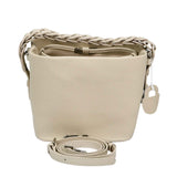 the MUNI Braided Handle Bucket Bag, a sophisticated blend of sculptural design and artisanal texture.