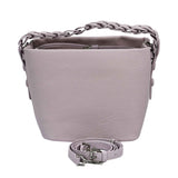 The MUNI Braided Handle Bucket Bag, a sophisticated blend of sculptural design and artisanal texture.