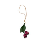 A handcrafted leather charm by MUNI featuring two magenta tulip buds and green leaves hanging from a gold ring and a tan leather cord, shown on a white background.