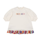 White baby dress with puffed sleeves, ribbed cuffs, a colourful zigzag embroidered Missoni logo, and a vibrant zigzag ruffled
