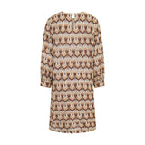 Multicolor dress with long sleeves, a repeating brown, beige, and gold-toned abstract pattern, and a keyhole back neckline.