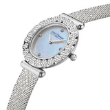 Diagonal overhead close-up displaying the iridescent texture of the mother-of-pearl dial, the four diamond hour markers, and the micro-textured fluted crown.