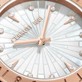 A close-up macro photograph detailing the intricate sunburst mosaic layout of the white mother-of-pearl dial, the rose gold hands, and the sparkling crystal accents.