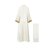 Back view of the cream Maison Darine abaya showing the sequin detailing on the sleeves and the clean, flowing drape of the shimmering fabric.