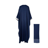 Back view of the navy Maison Darine kaftan showing the generous, flowing fabric and silver-white embroidery detailing on the sleeve cuffs.