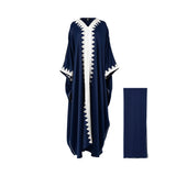Front view of a floor-length navy blue Maison Darine kaftan featuring white geometric embroidery on the neckline, center front, and sleeves, shown with a matching navy sheila.