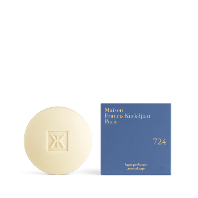 The Maison Francis Kurkdjian 724 scented soap bar displayed next to its vibrant blue square packaging with gold-stamped lettering.