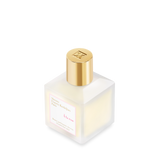 A angled view of  frosted glass bottle of Maison Francis Kurkdjian Paris "À la rose" Scented Hair Mist (70ml) with a gold cap and a white label featuring pink and gold lettering.