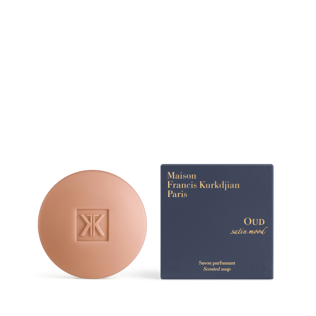 The OUD satin mood scented soap bar shown alongside its elegant deep navy blue square box featuring gold-foil lettering.