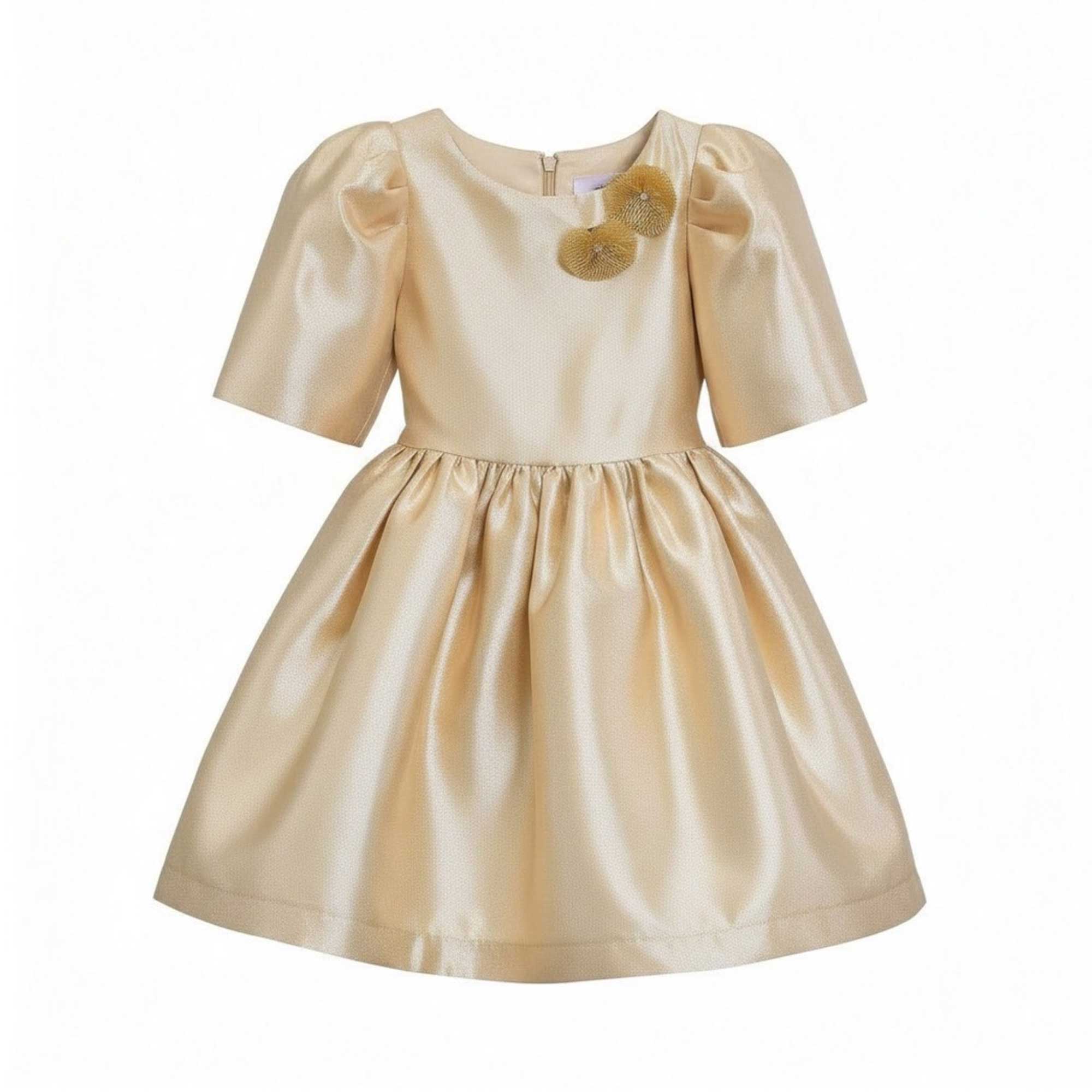 Front full-length view of the Mamaluma girls gold metallic party dress showing the puff sleeves, gathered full skirt, and two floral accent appliqués near the neckline.