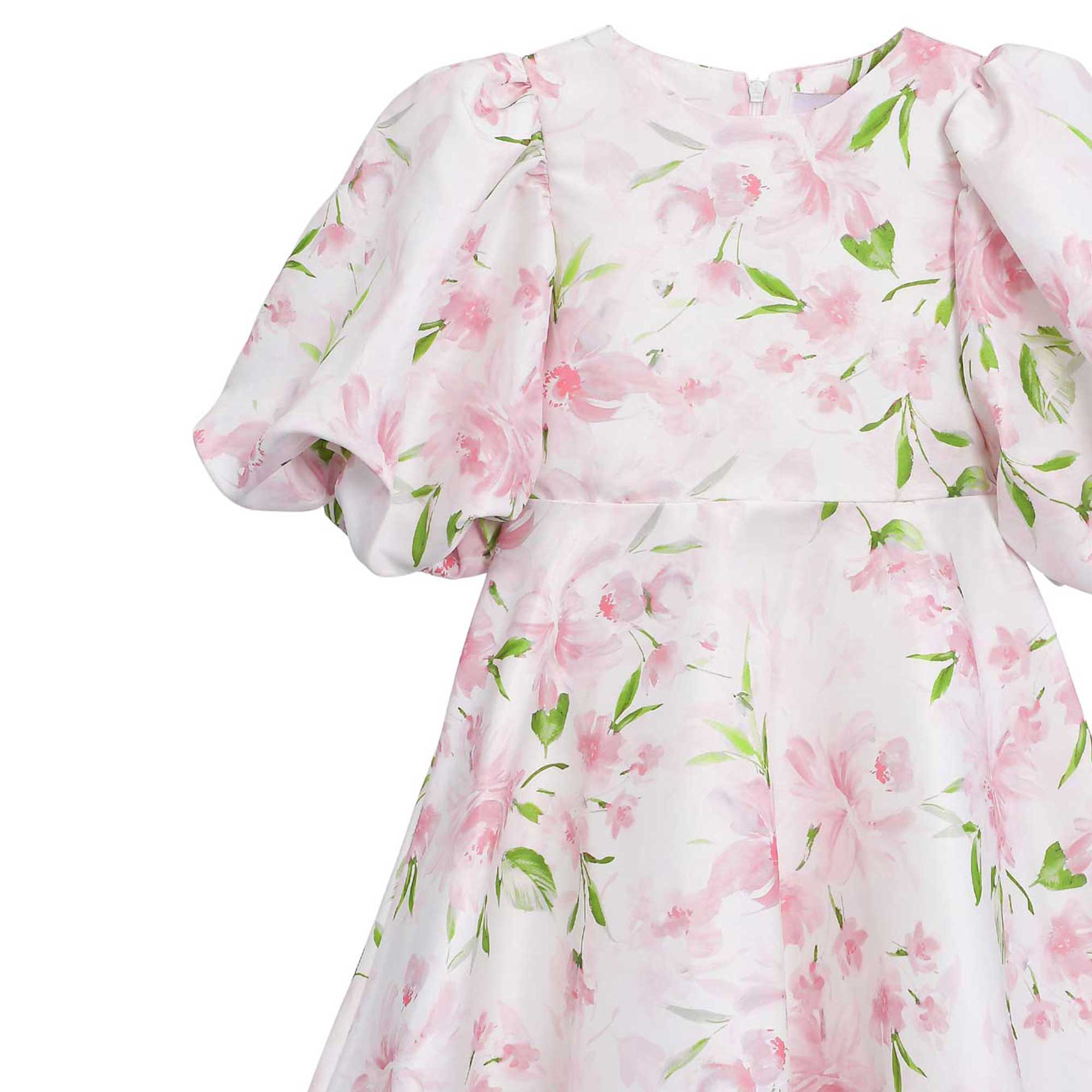 Close-up front view detailing the bodice, clean crew neckline, gathered dramatic puff sleeve construction, and watercolor floral pattern fabric.