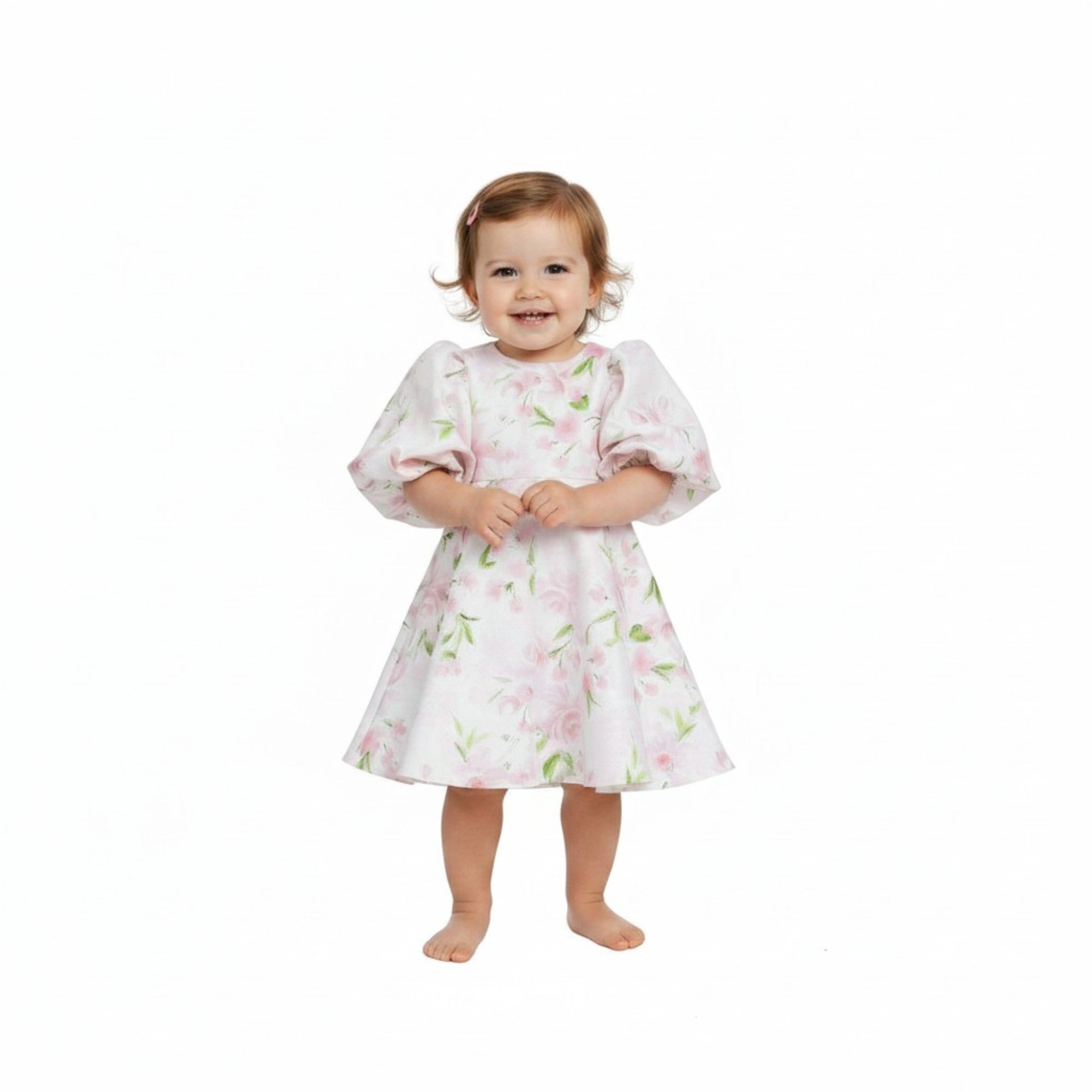 Child wearing a floral dress on a white background.