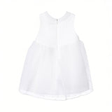 Back view of the Mamaluma girls sleeveless white Swiss dot dress highlighting the gathered tulle skirt waistline and a clean, concealed zipper closure.