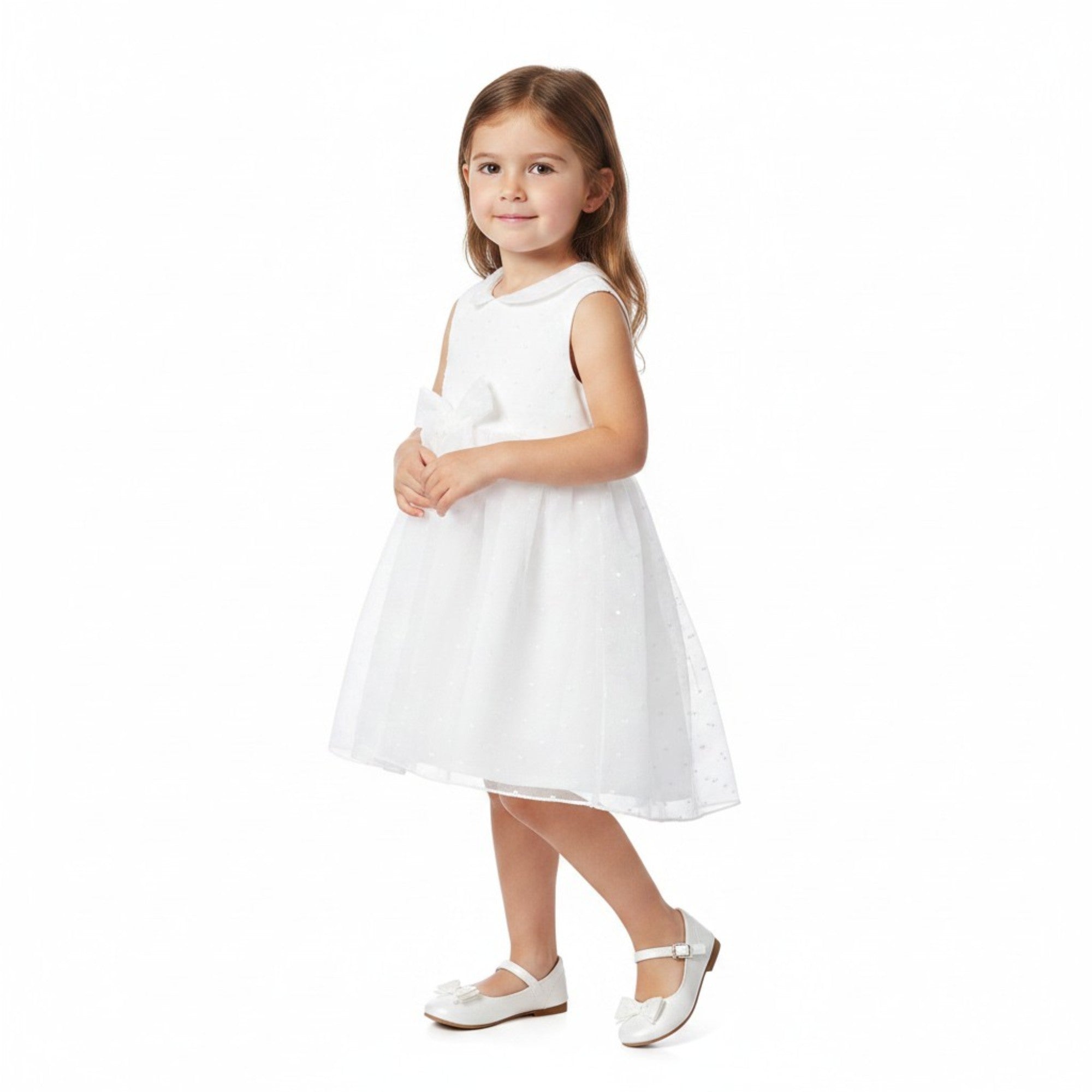 Young girl wearing a white dress on a white background.