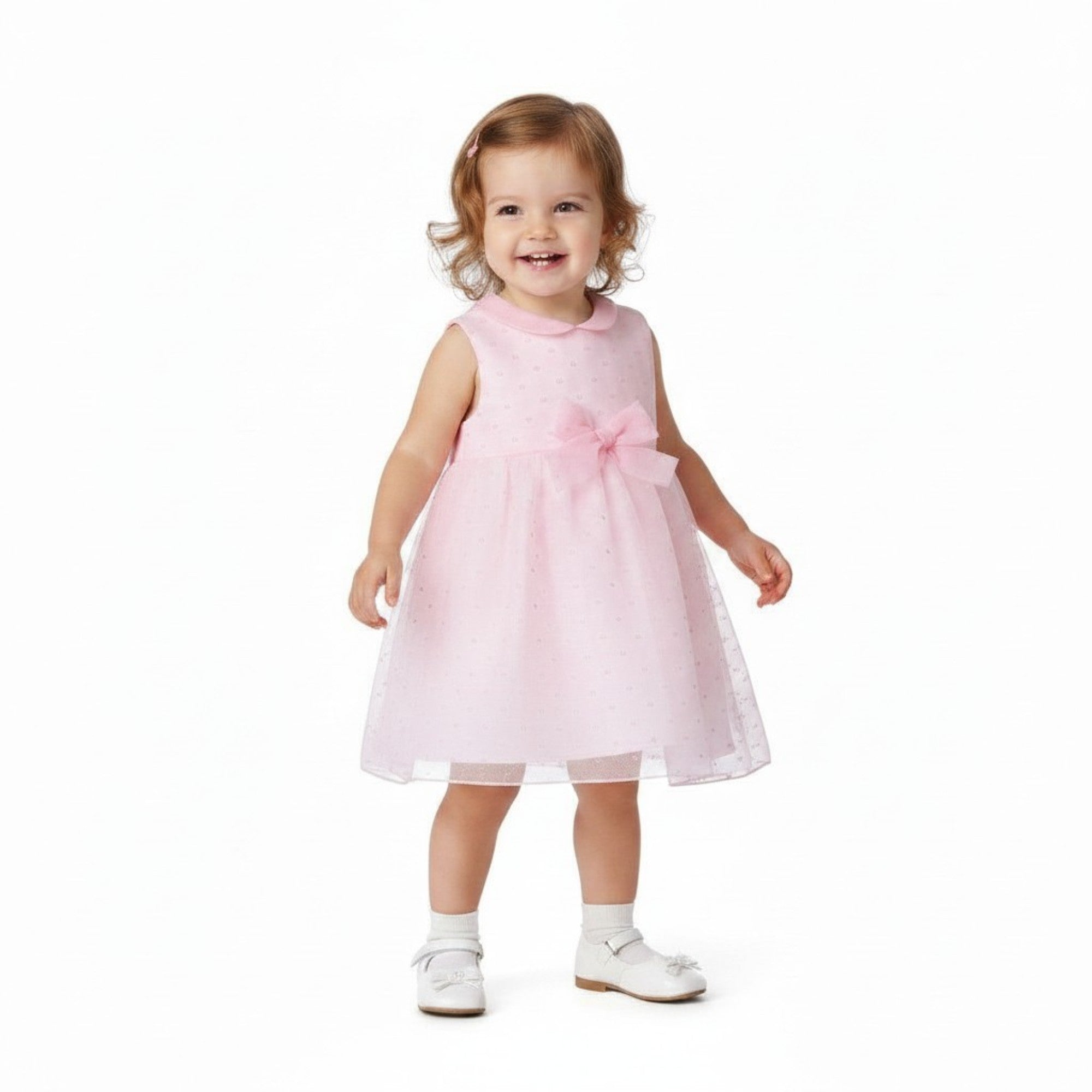 Child wearing a pink dress with a bow on a white background.
