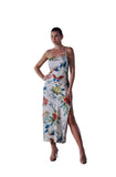 Model wearing Marjolaine ivory silk slip dress with floral butterfly print and high side slit available at BLUE SALON.