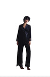 Model wearing Marjolaine dark velvet wrap jacket sitting by window available at BLUE SALON