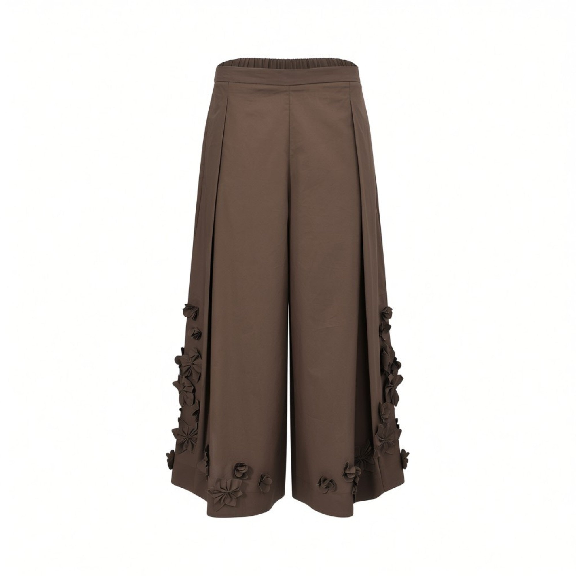 Front view of Meimeij brown wide-leg culotte trousers showcasing structural front pleats and detailed 3D fabric flowers along the outer side seams and hem against a white background.