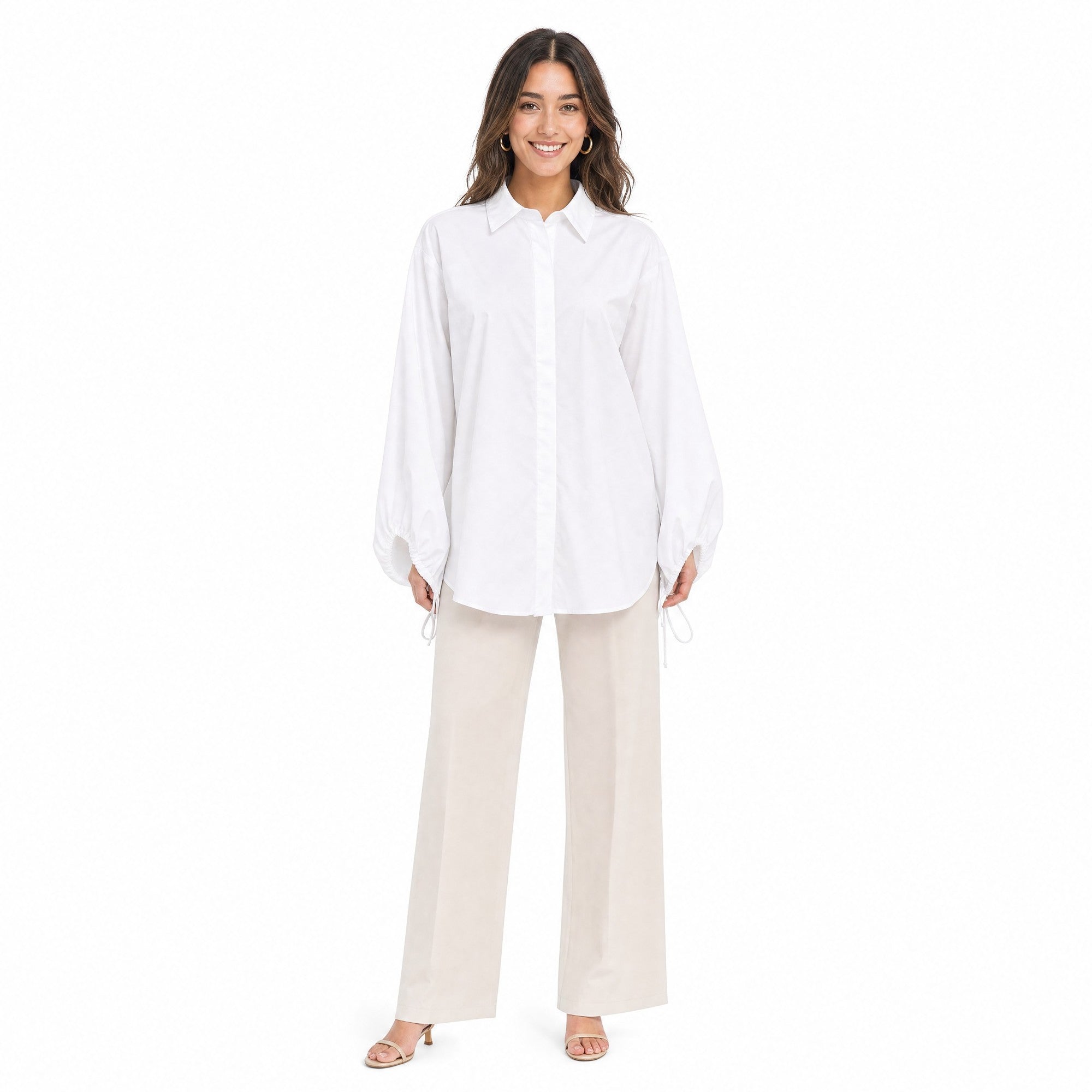 Full-length front view of a model wearing the Meimeij oversized white button-down shirt paired with tailored beige wide-leg trousers from BLUE SALON shop.