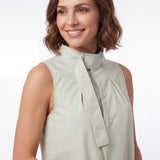 Three-quarter close-up view of the model highlighting the intricate loop design, attached scarf detail, and delicate pleating on the Meimeij mint green blouse.