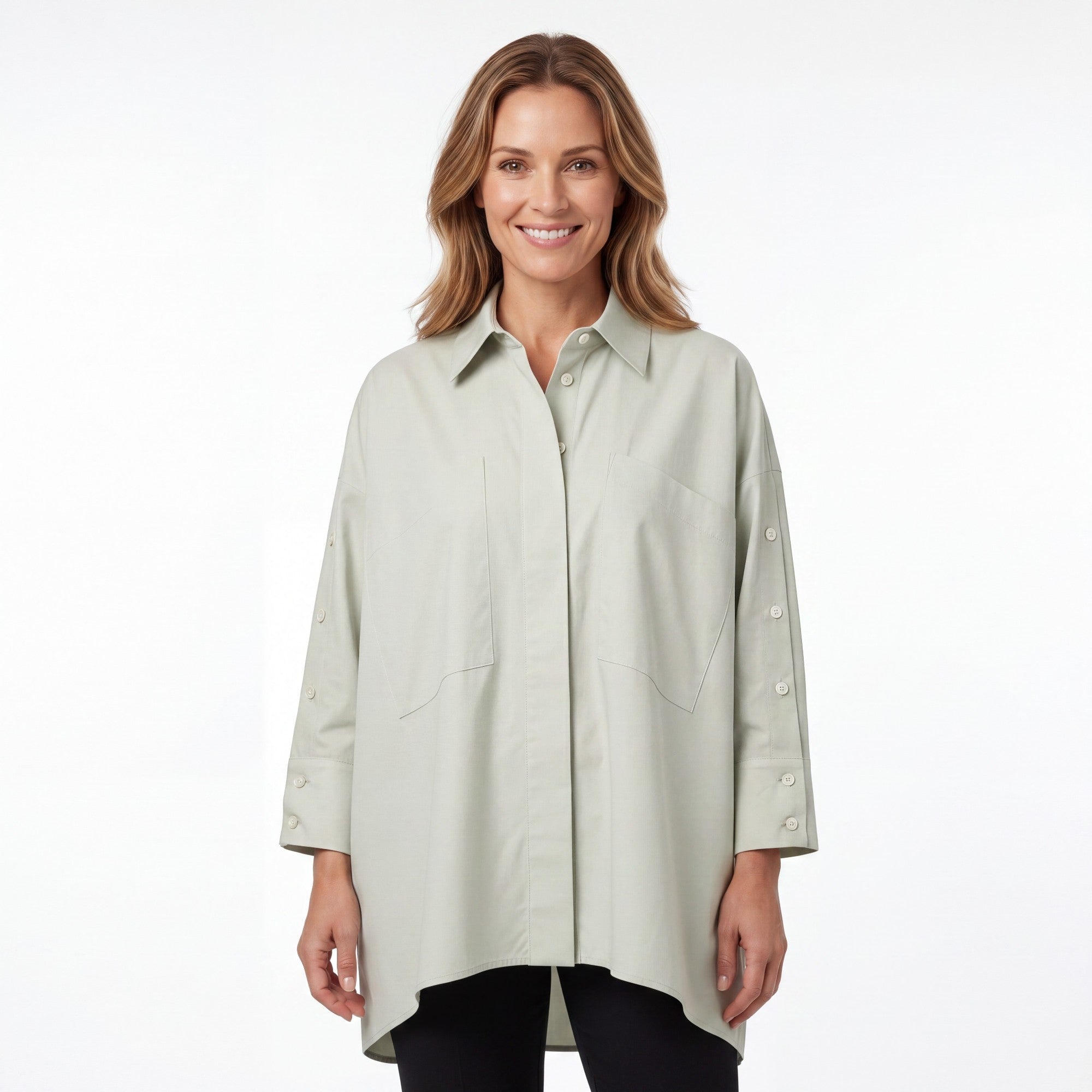 Front view of a smiling model wearing the Meimeij oversized sage green button-down shirt paired with dark trousers.