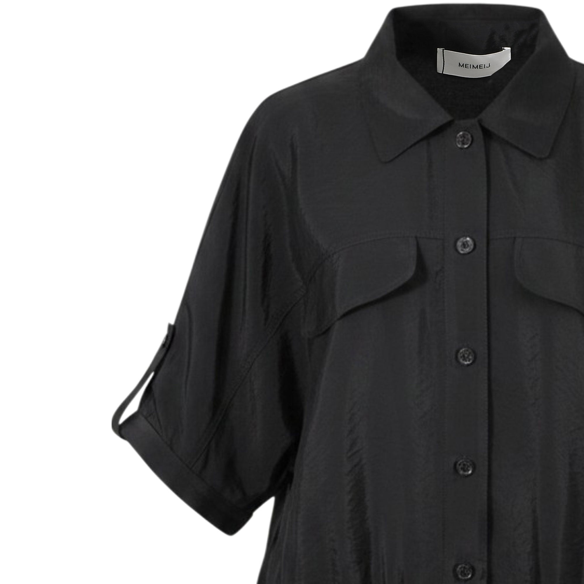 Close-up shot of the Meimeij black blouse detailing the pointed collar, tonal buttons, utility pocket flap, and sleeve button-tab from BLUE SALON shop.
