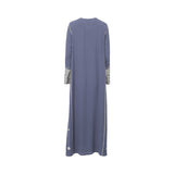 Back view of the Mijade Fashion slate blue maxi dress showing embroidered vertical side seams and delicate floral stitch details at the hem.