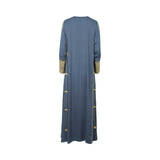 Back view of a floor-length lavender purple kaftan by Mijade Fashion showing a clean silhouette with gold embroidery accents on the side seams and sleeves.