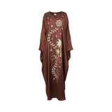 Front view of a chocolate brown Mijade Fashion kaftan dress featuring gold and silver embroidery of palm trees, stars, and vines on a white background.