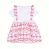 Back view of a white Missoni baby girl dress displaying snap-button closures along the center back and colorful chevron-patterned shoulder ruffles.