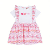Front full-length view of a white Missoni baby girl dress featuring a signature pink, orange, and purple zigzag pleated skirt and shoulder ruffles.