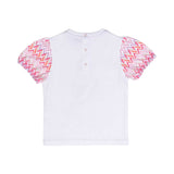 Detailed back view of the white baby t-shirt, showcasing the signature print on the puff sleeves and three neat snap-button fasteners along the neckline.