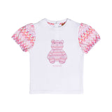 Detailed front view of the white Missoni baby t-shirt, highlighting the center graphic and the pink-toned zigzag puff sleeves.