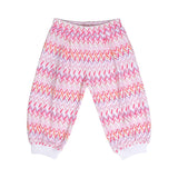 Front view of the loose-fit Missoni baby pants, displaying an all-over chevron pattern in shades of pink, orange, and purple with white ribbed ankle cuffs.