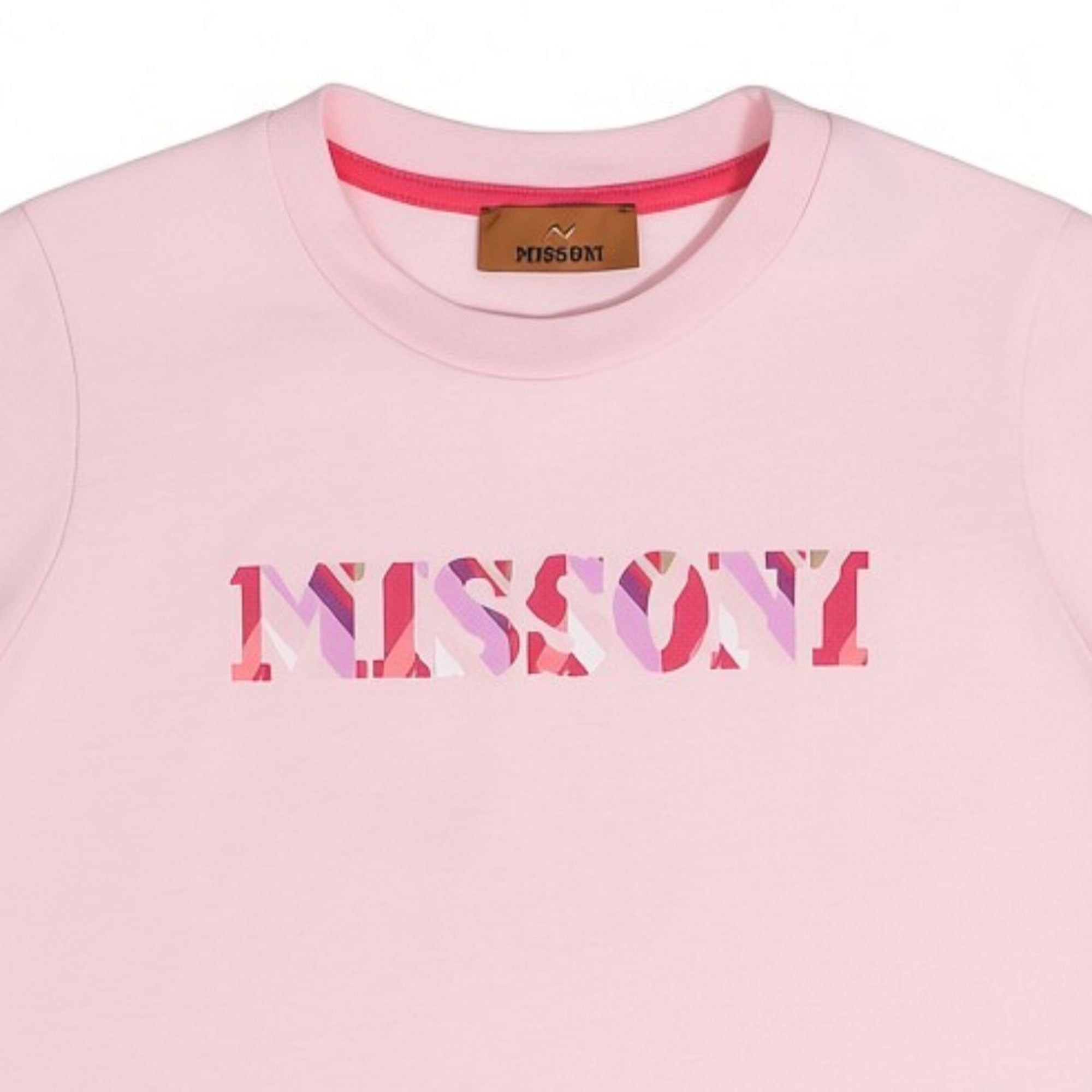 Close-up detailed shot of the Missoni pink T-shirt neckline, showing the brown branded inner label and the pink, purple, and red patterned zigzag logo text print.