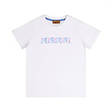 Front flat-lay view of a Missoni white short-sleeved cotton T-shirt featuring the MISSONI logo printed in a multi-colored zigzag pattern across the chest.