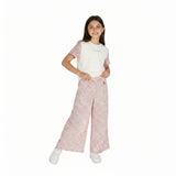 Young girl wearing a white shirt with pink floral sleeves and matching pants on a white background.