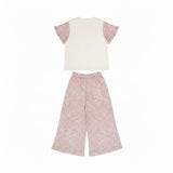 Back full view of the Missoni kids casual coordinates set showing the plain off-white back of the top and the fluid drape of the patterned pink wide-leg trousers.