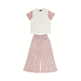 Front full view of a Missoni kids two-piece set featuring an off-white T-shirt with pink zigzag knit sleeves and matching abstract pink wide-leg trousers.