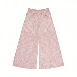 Front view of the Missoni kids knit trousers showcasing a wide-leg cut, an elasticized waistband, and an all-over abstract zigzag pattern in shades of pink.