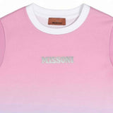 Close-up detailed view of the Missoni kids T-shirt neckline, showcasing the white contrast collar, brown leather brand label, and the tonal embroidered MISSONI text logo on pink fabric.