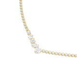 A macro studio close-up of the Swarovski Mesmera necklace's focal point, detailing the precise facets of the large pear, marquise, and oval white crystals beautifully clustered in their gold prong settings.
