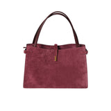 Maroon handbag with brown handles on a white background.