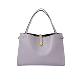 Light gray handbag with a yellow tag on a white background.