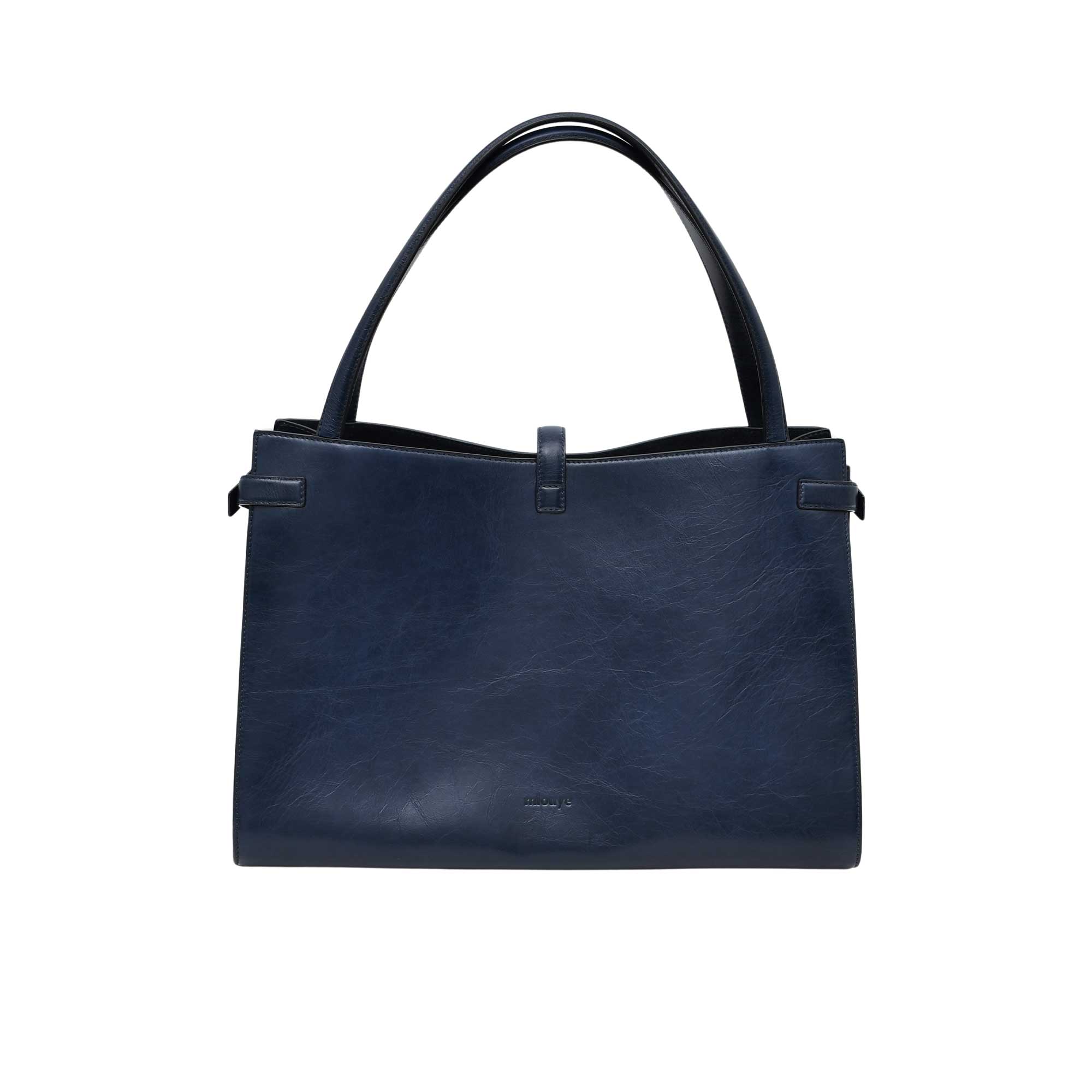Navy blue handbag with a strap on a white background.