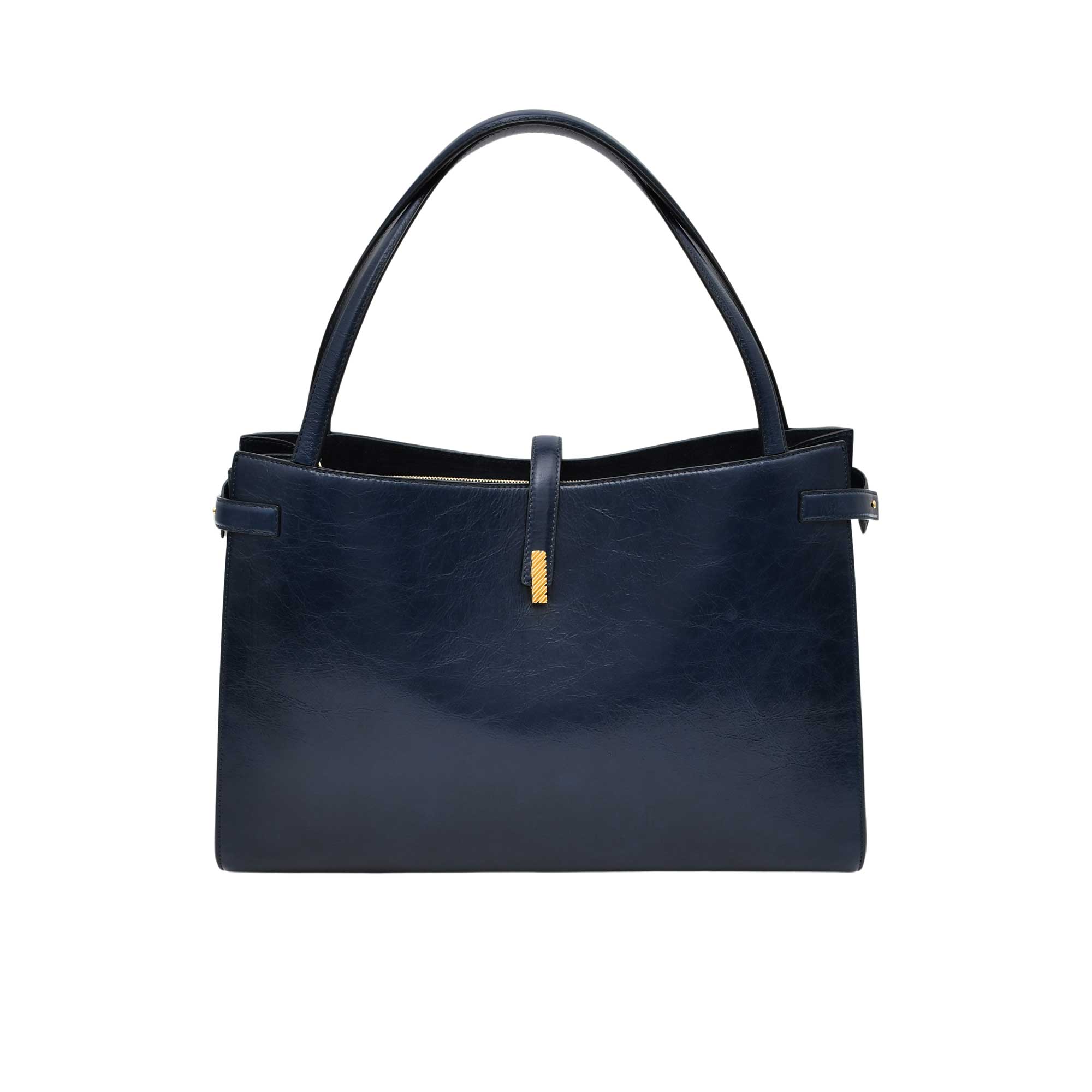 Navy blue handbag with gold clasp on a white background.