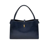 Navy blue handbag with gold clasp on a white background.
