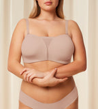 Model Front view of the Triumph Flex Smart beige non-wired bra with detachable straps and a smooth, seamless finish. Shop Online Today