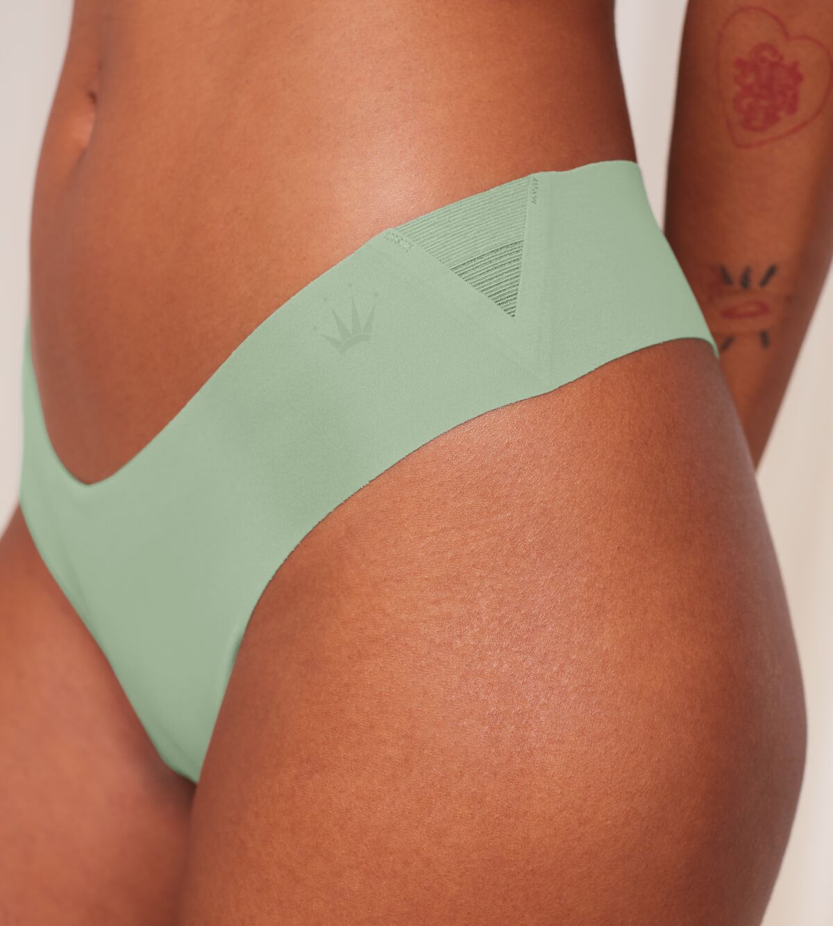 Model clos-up view of the Triumph Flex Smart green high-leg Brazilian panty, showcasing the smooth elastic fabric and modern silhouette. Now Available Online