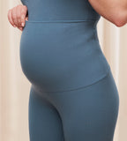 Model close-up angled view of the Triumph Natural Spotlight blue rib comfort stretch trousers, highlighting the pregnancy-friendly waistband and wide-leg cut. Shop Online